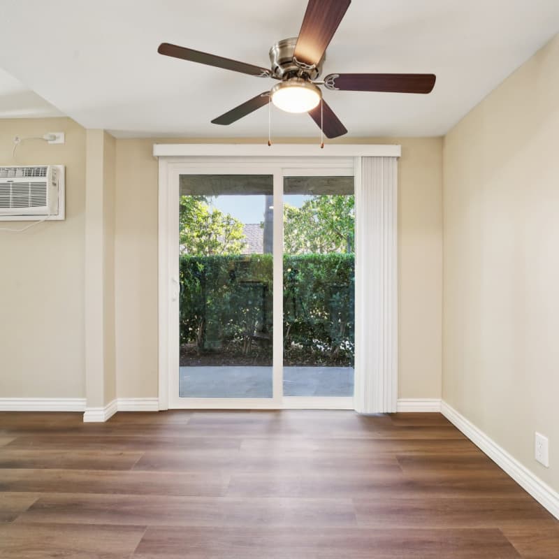 Spacious open living room layout with entry to patio at North Pointe Villas in La Habra, California