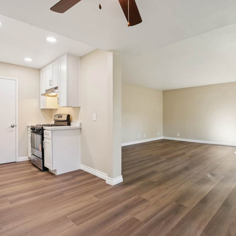 Kitchen with open living room layout at North Pointe Villas in La Habra, California