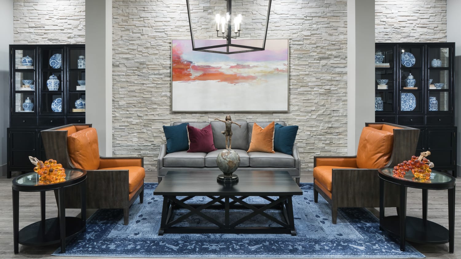 Community lounge at our active adult living apartments in Lakewood, CO, featuring ample seating including upholstered chairs. 