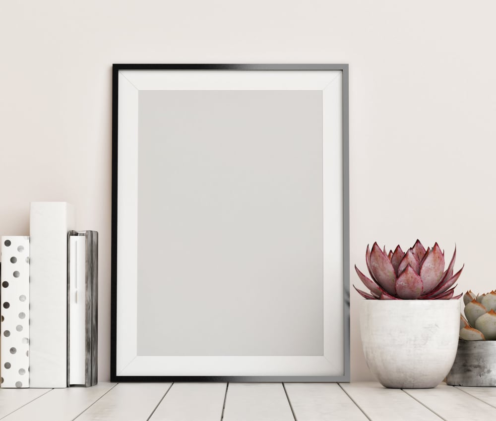 Pictures and plants on table at Heatherwood Apartments in Sacramento, CA