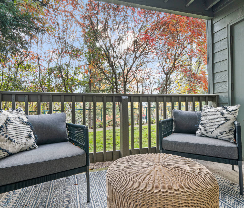 Large patio with a view of the grass and trees on the grounds at Timbers at Tualatin in Tualatin, Oregon