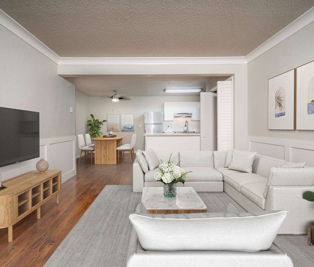 Spacious living room with sectional sofa and TV at Breakwater Apartments in Santa Cruz, California