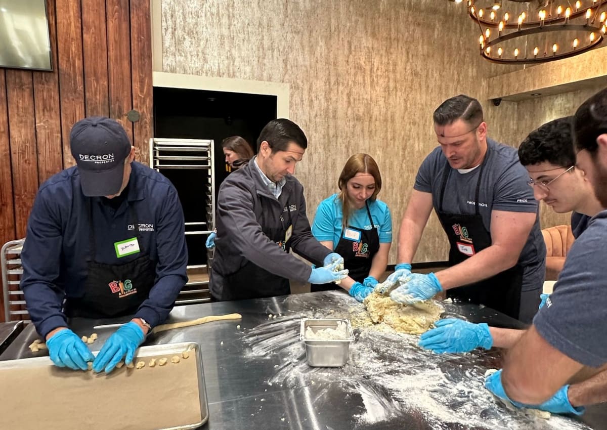 Team mates volunteer to help prepare meals Decron Properties, Los Angeles, California