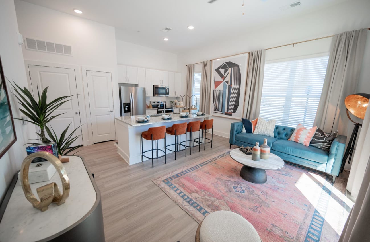 Well-furnished dining and living areas in a model apartment at The Enzo at Ariston in Buford, Georgia