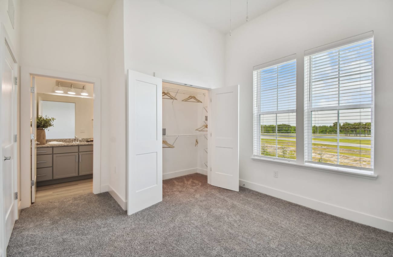 2 BR Apartments in Ponte Vedra Beach, FL - Cadence at Nocatee - Plush Carpeted Bedroom with Two-Door Closet and In-Suite Bathroom.