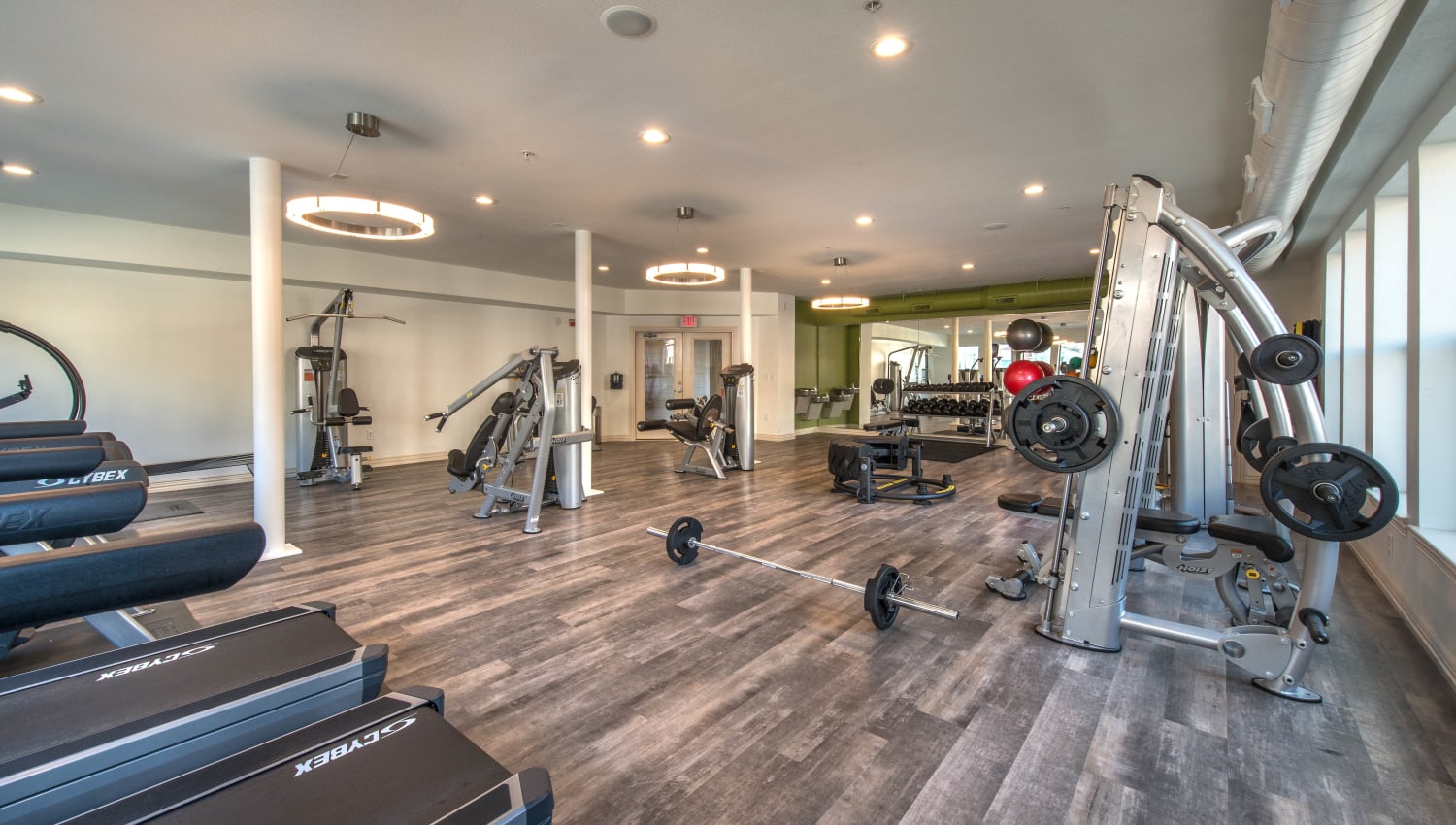 Treadmills and free weights in the onsite fitness center at Olympus Las Colinas in Irving, Texas