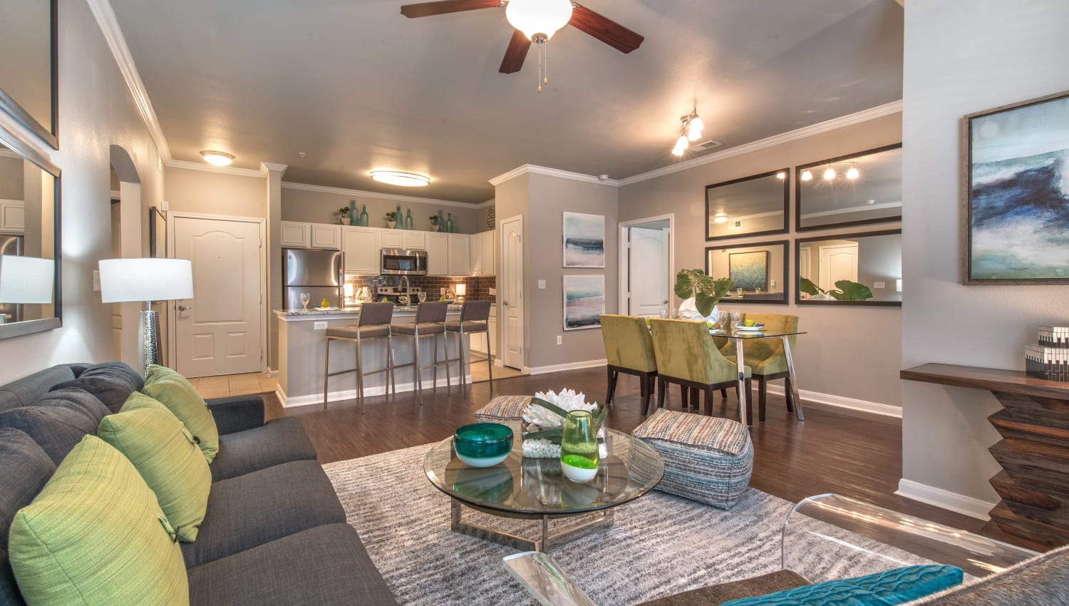Well-furnished model apartment's living space at Olympus Las Colinas in Irving, Texas