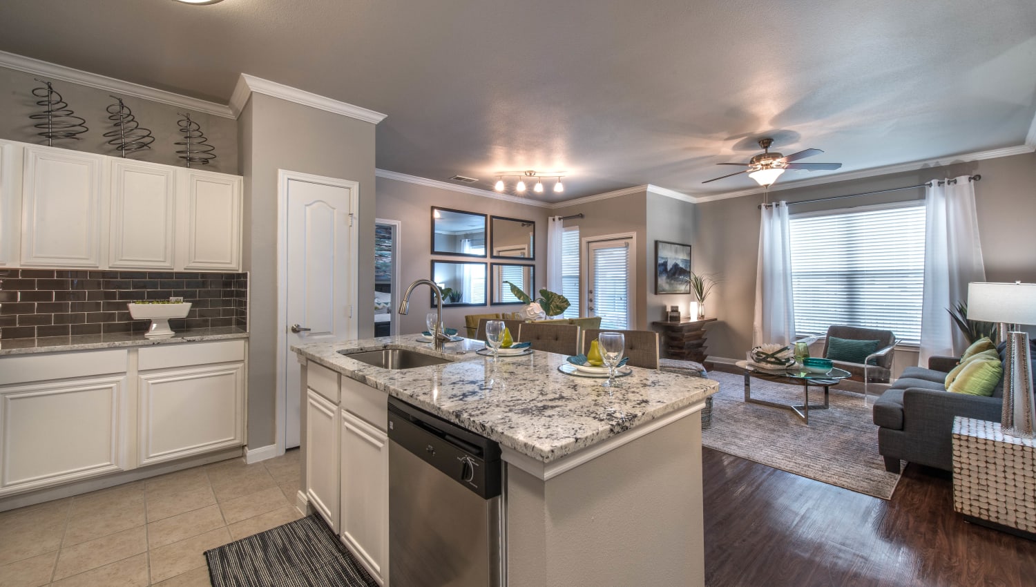 View of the living area from a model apartment's kitchen at Olympus Las Colinas in Irving, Texas