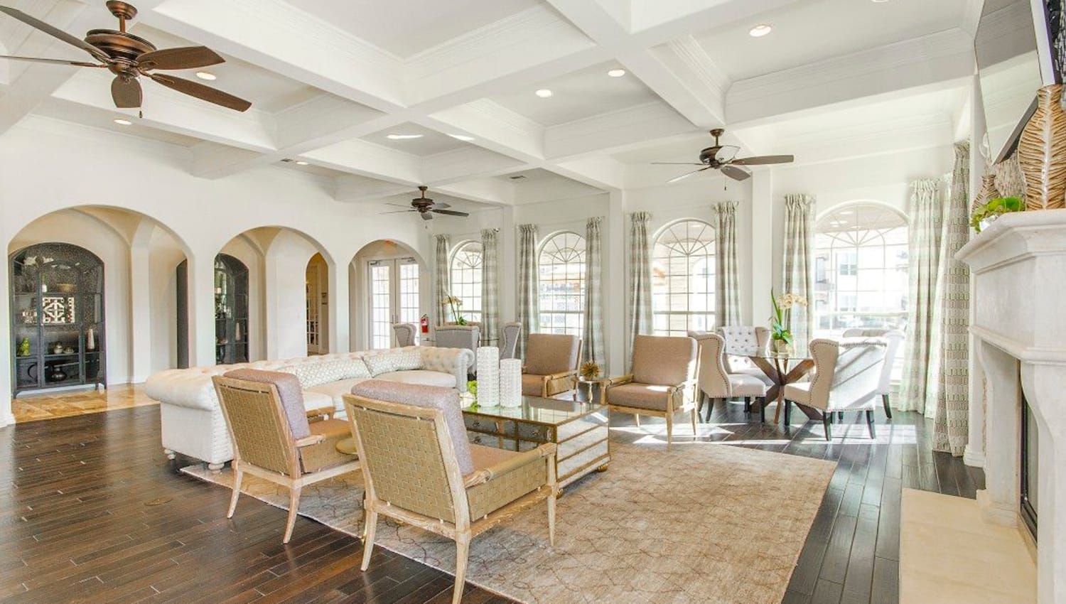 Classic furnishings and beautiful hardwood flooring in the clubhouse at Olympus Woodbridge in Sachse, Texas