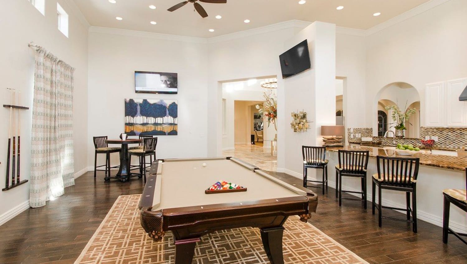 Game room with a billiards table and more in the clubhouse at Olympus Woodbridge in Sachse, Texas