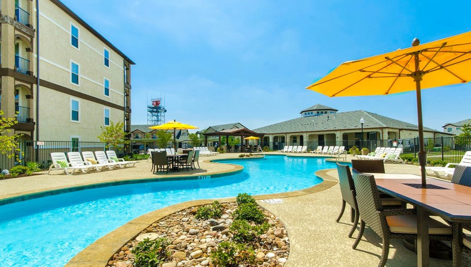 Winding pool with great places to sit in the shade nearby at Olympus Woodbridge in Sachse, Texas