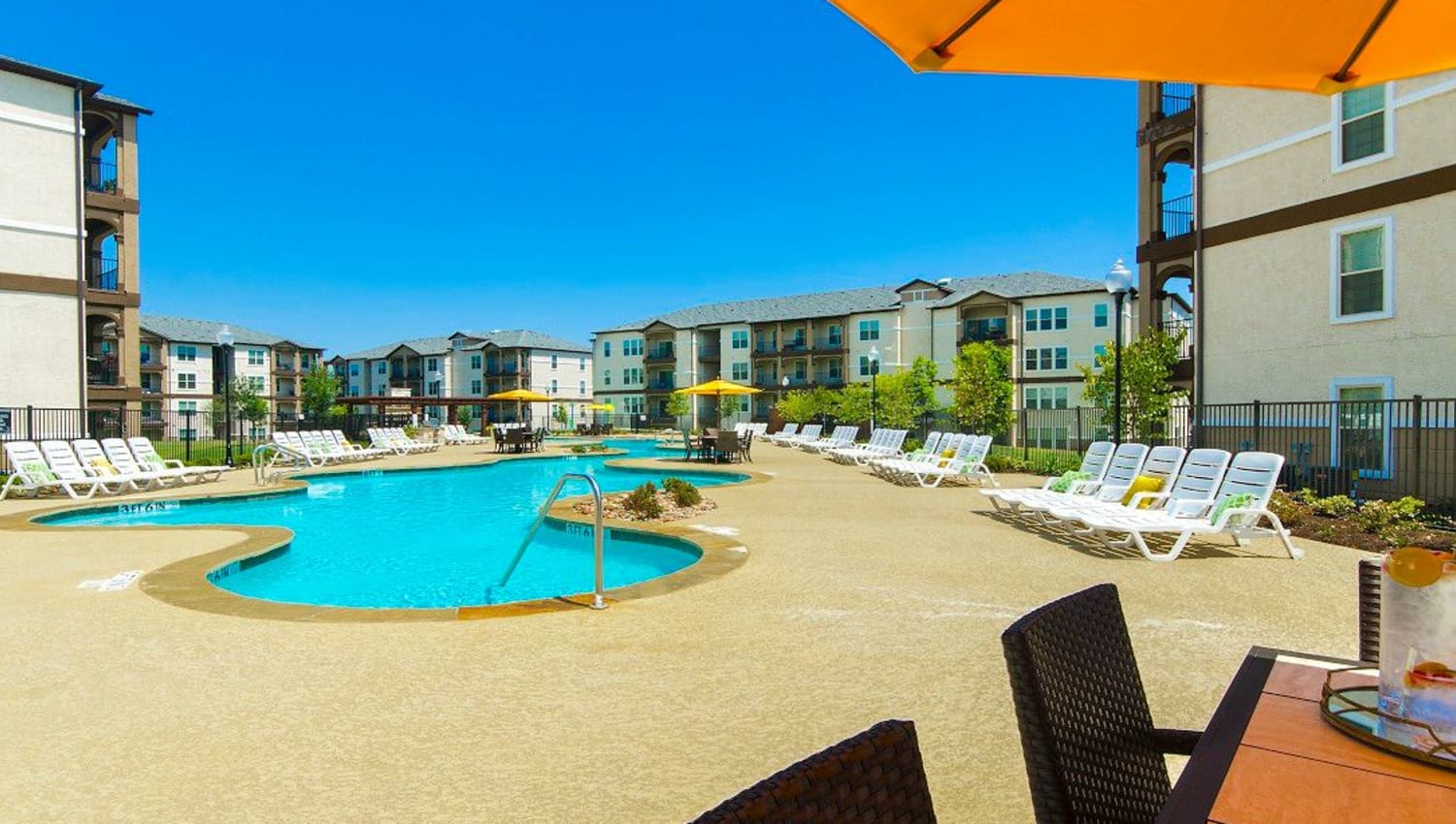 Beautiful day at the swimming pool area at Olympus Woodbridge in Sachse, Texas
