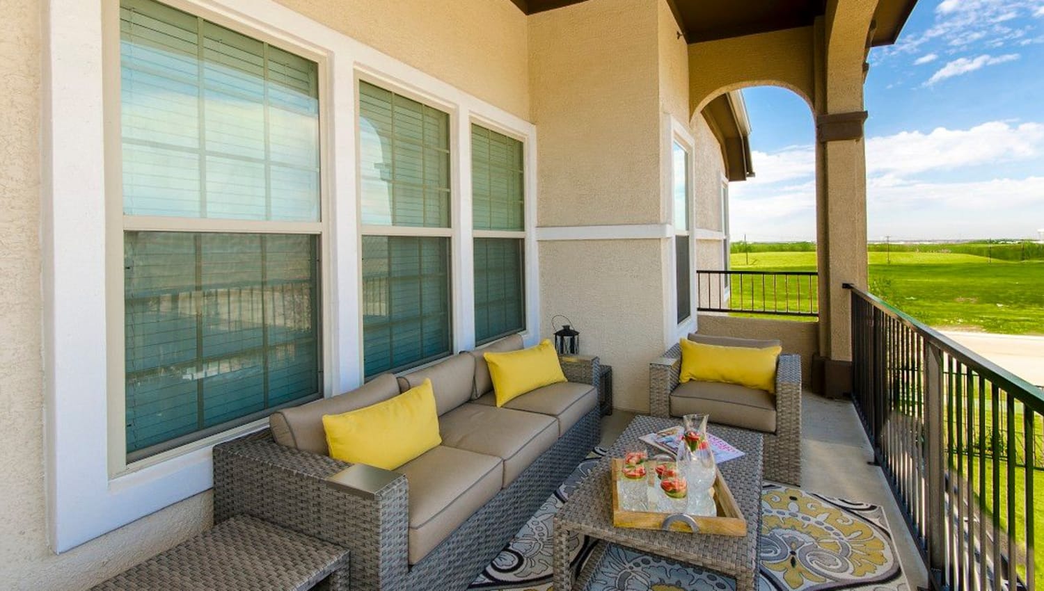 Expansive and well-furnished private balcony outside a model townhome at Olympus Woodbridge in Sachse, Texas