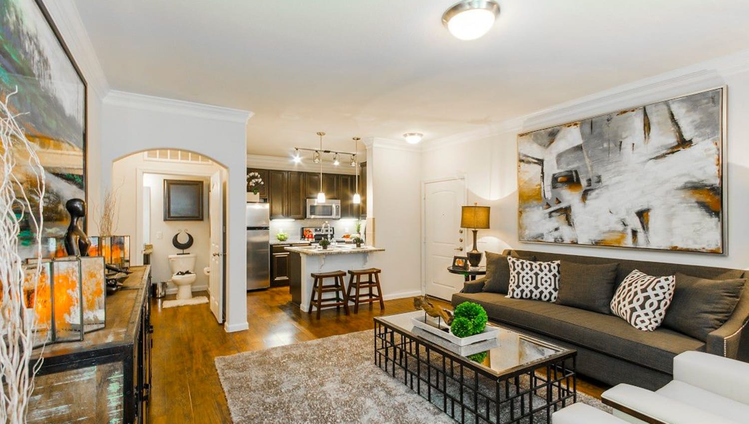 Very well-furnished model apartment's living area at Olympus Woodbridge in Sachse, Texas