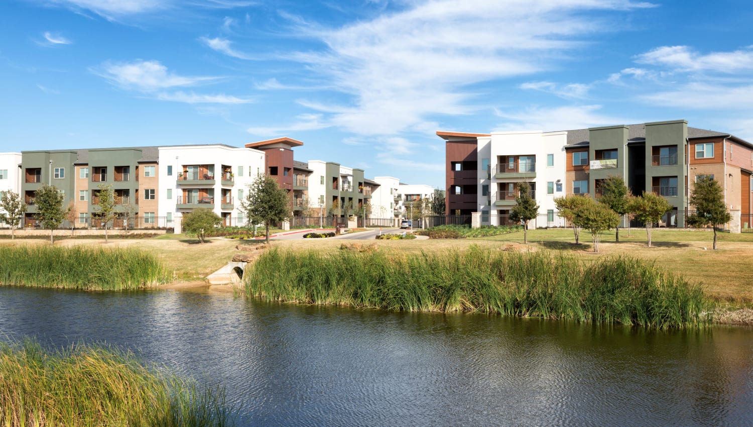 Resident buildings near the lake at The Davis in Fort Worth, Texas