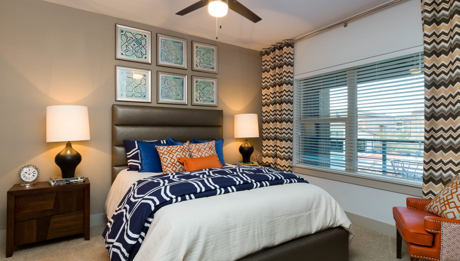Large bay windows and colorful decor in a model home's bedroom at The Davis in Fort Worth, Texas