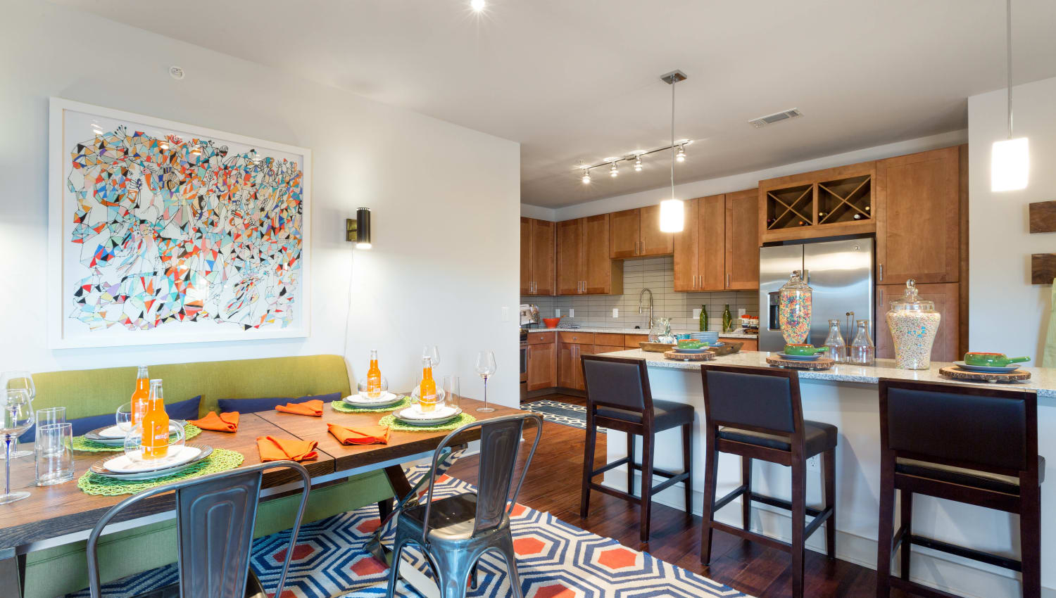 Well-furnished dining area next to the kitchen in a model home at The Davis in Fort Worth, Texas