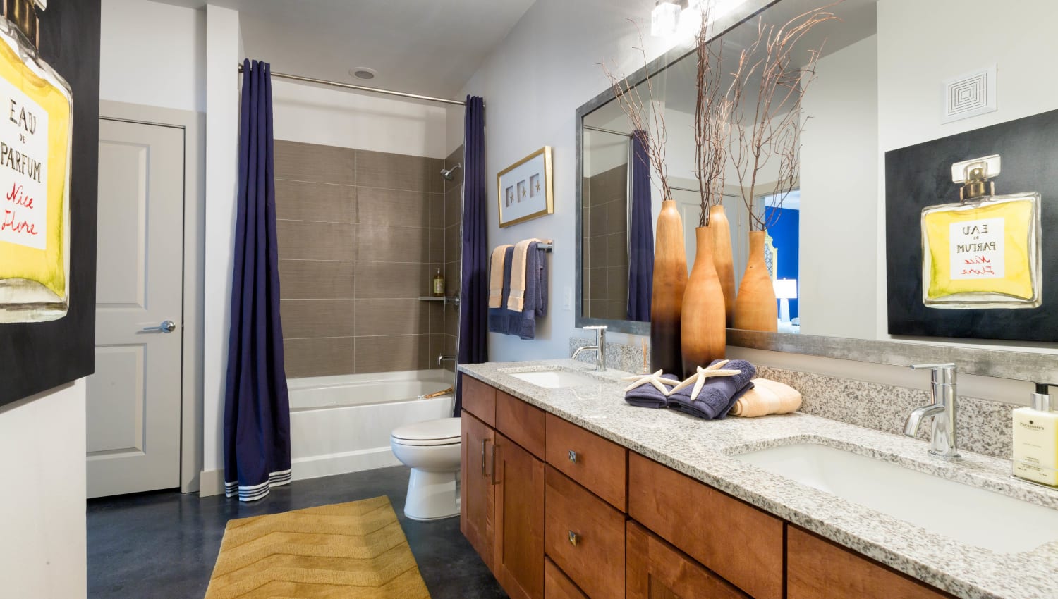Spacious primary bathroom with a custom tiled shower in a model home at The Davis in Fort Worth, Texas