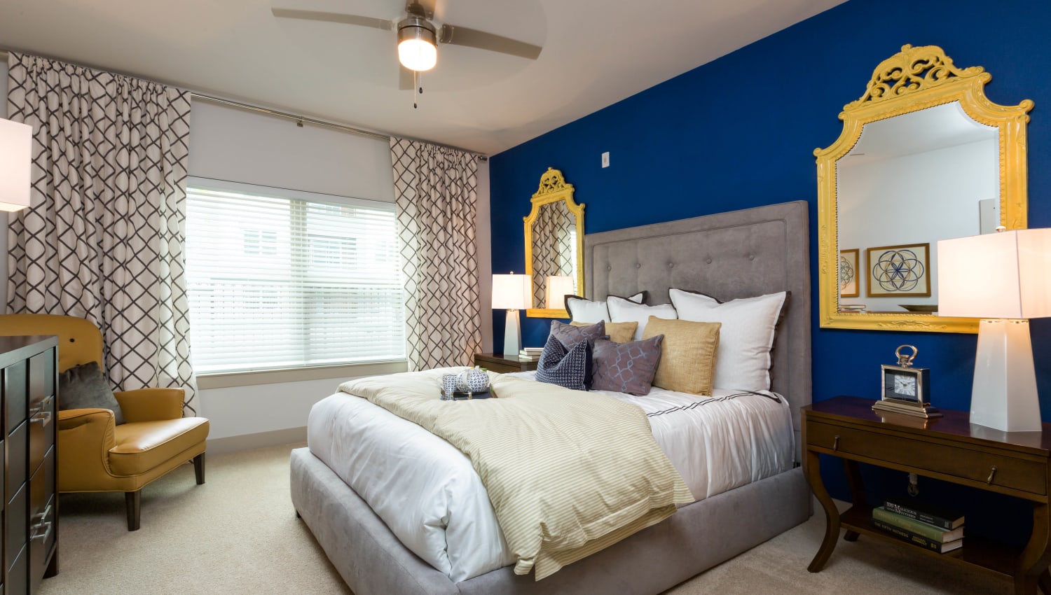 Plush carpeting and an accent wall in a model home's primary bedroom at The Davis in Fort Worth, Texas