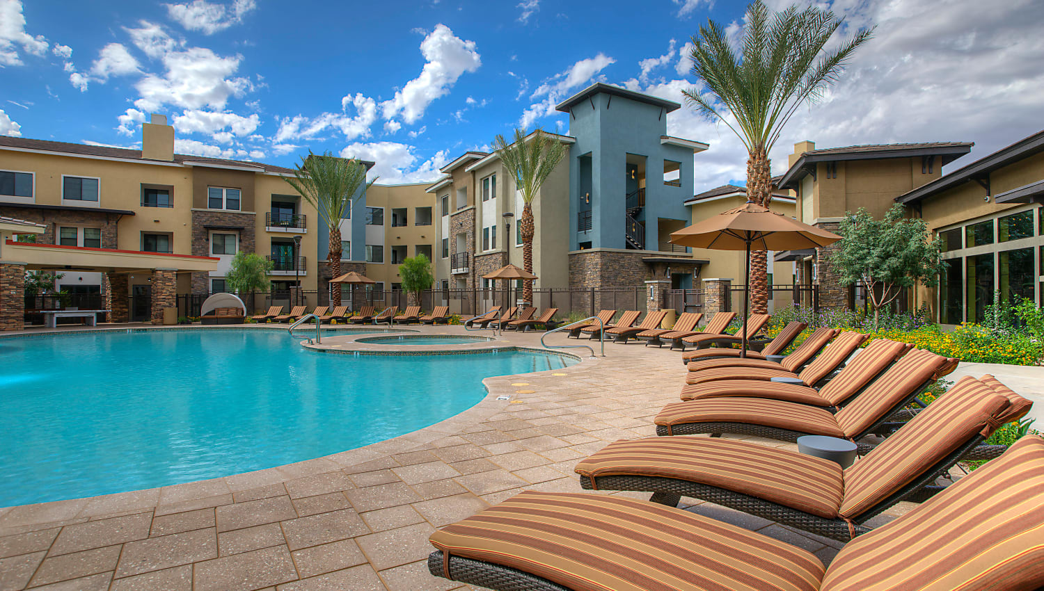 Luxurious lounge chairs along the resort-style swimming pool at Vistara at SanTan Village in Gilbert, Arizona