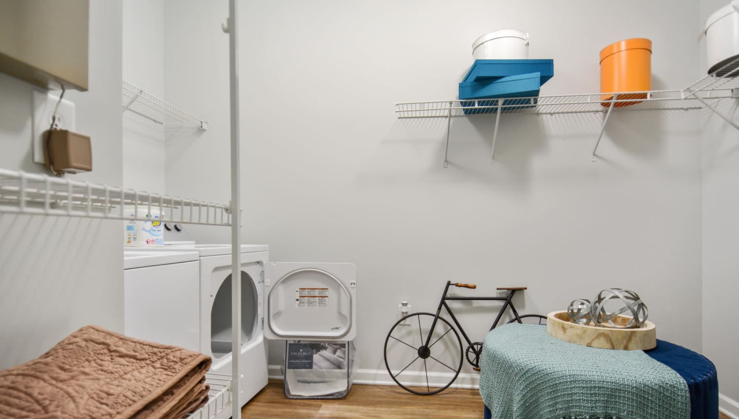 Spacious laundry room with shelving for storage in a model apartment at Ellington Midtown in Atlanta, Georgia