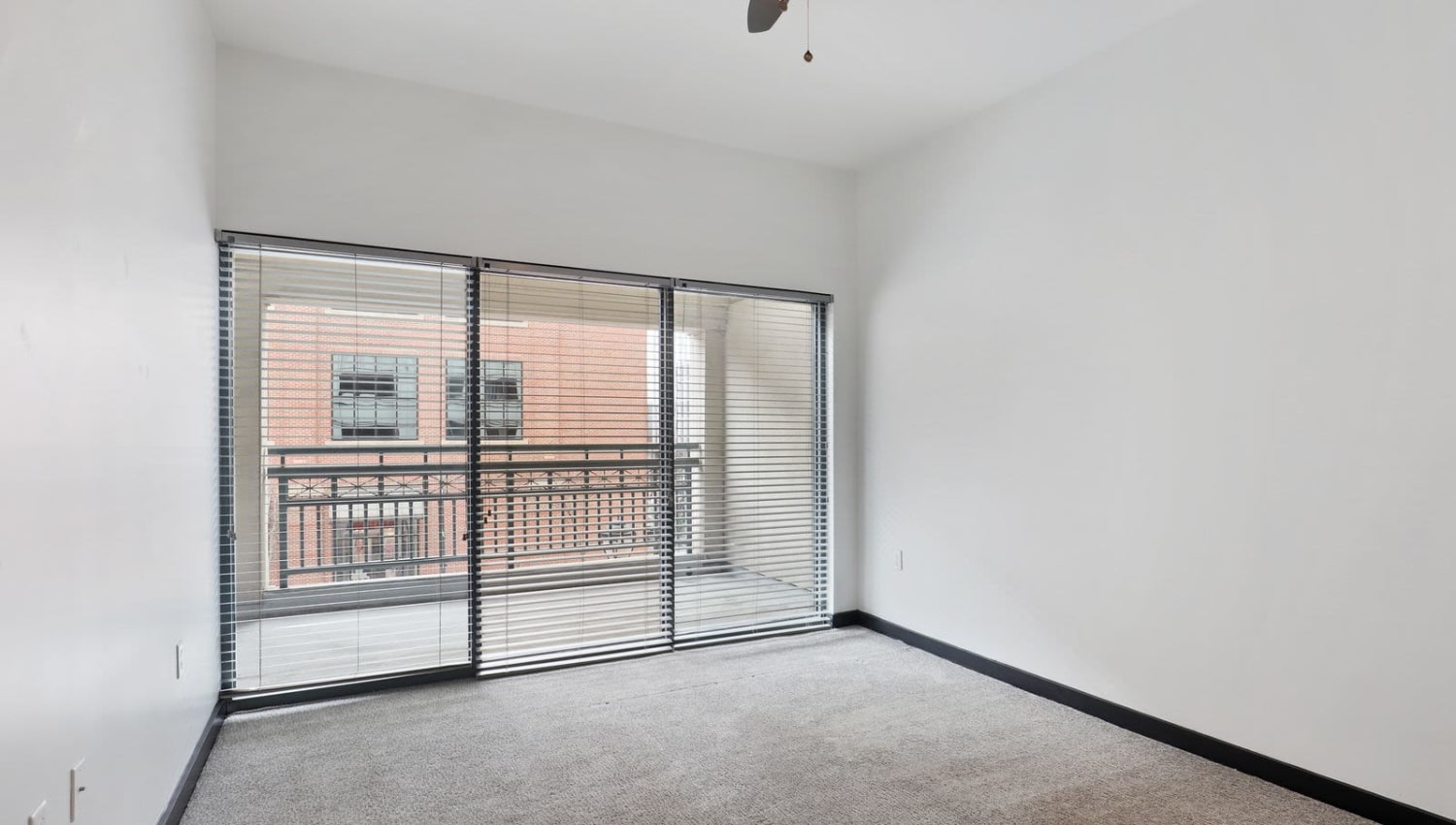 Bright bedroom with large floor to ceiling windows at 17th Street Lofts in Atlanta, Georgia