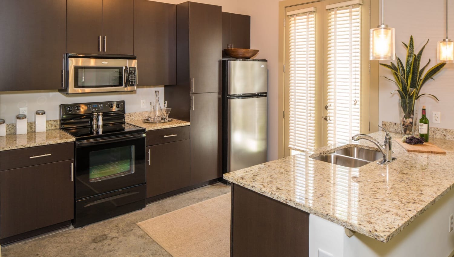Kitchen with granite counters at Optimist Lofts in Atlanta, Georgia