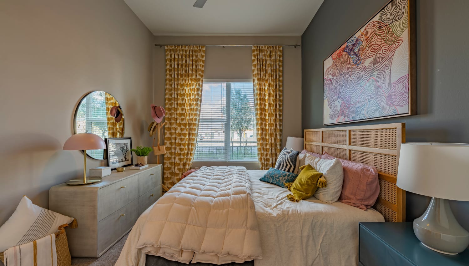 A bedroom with a large window at The Tessera in Phoenix, Arizona