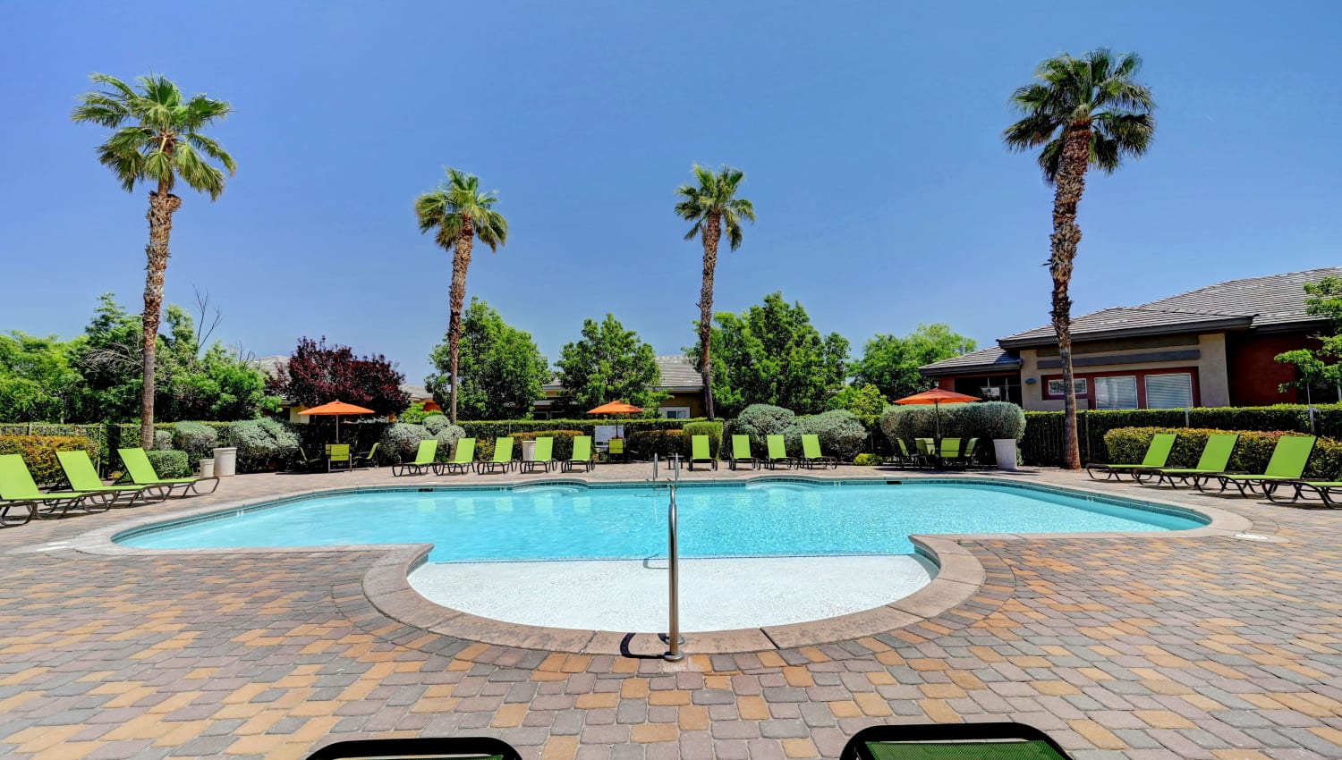 Swimming pool surrounded by palm trees at Canyon Villas Apartments in Las Vegas, Nevada