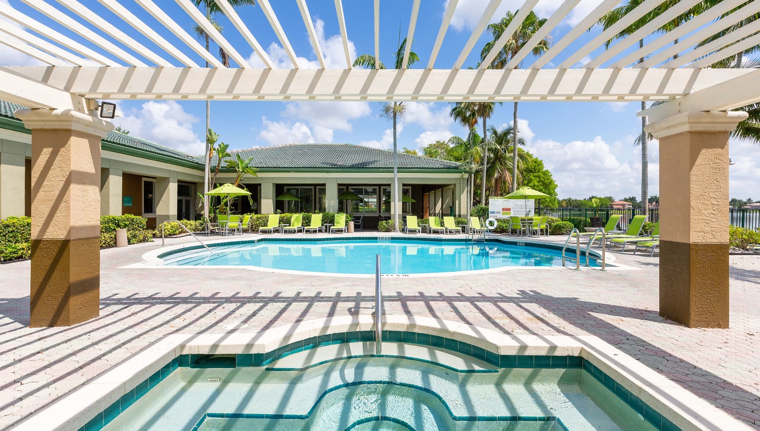 Sparkling pool and jacuzzi at Club Lake Pointe Apartments in Coral Springs, Florida