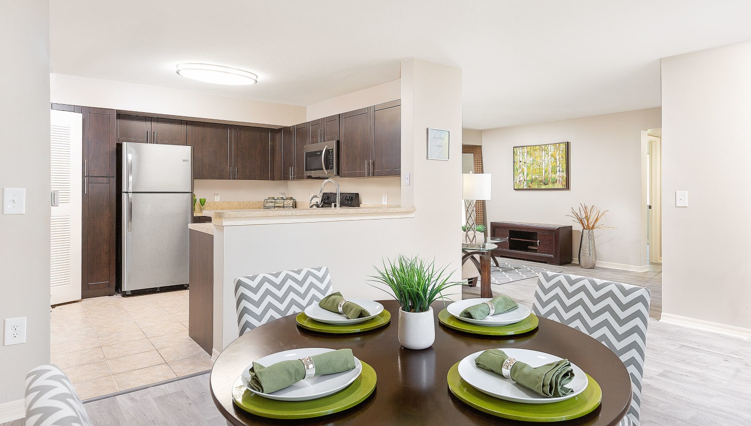 Model kitchen and dining area at Club Lake Pointe Apartments in Coral Springs, Florida