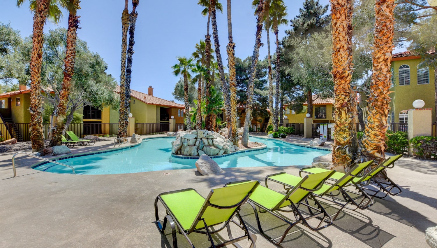 Sparkling pool with lounge chairs at Breakers Apartments in Las Vegas, Nevada