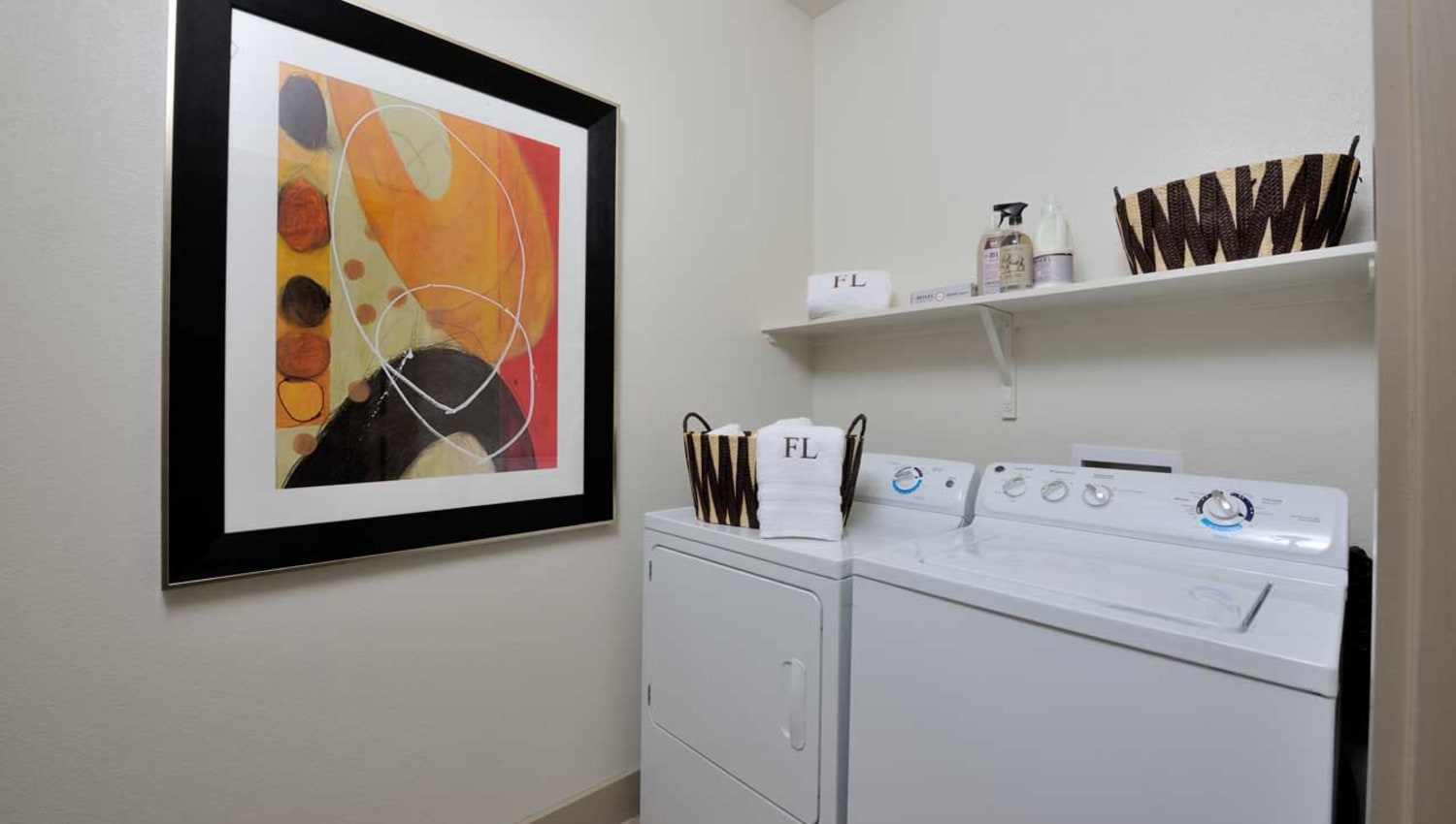 Full size washer and dryer in laundry room at Olympus Falcon Landing in Katy, Texas