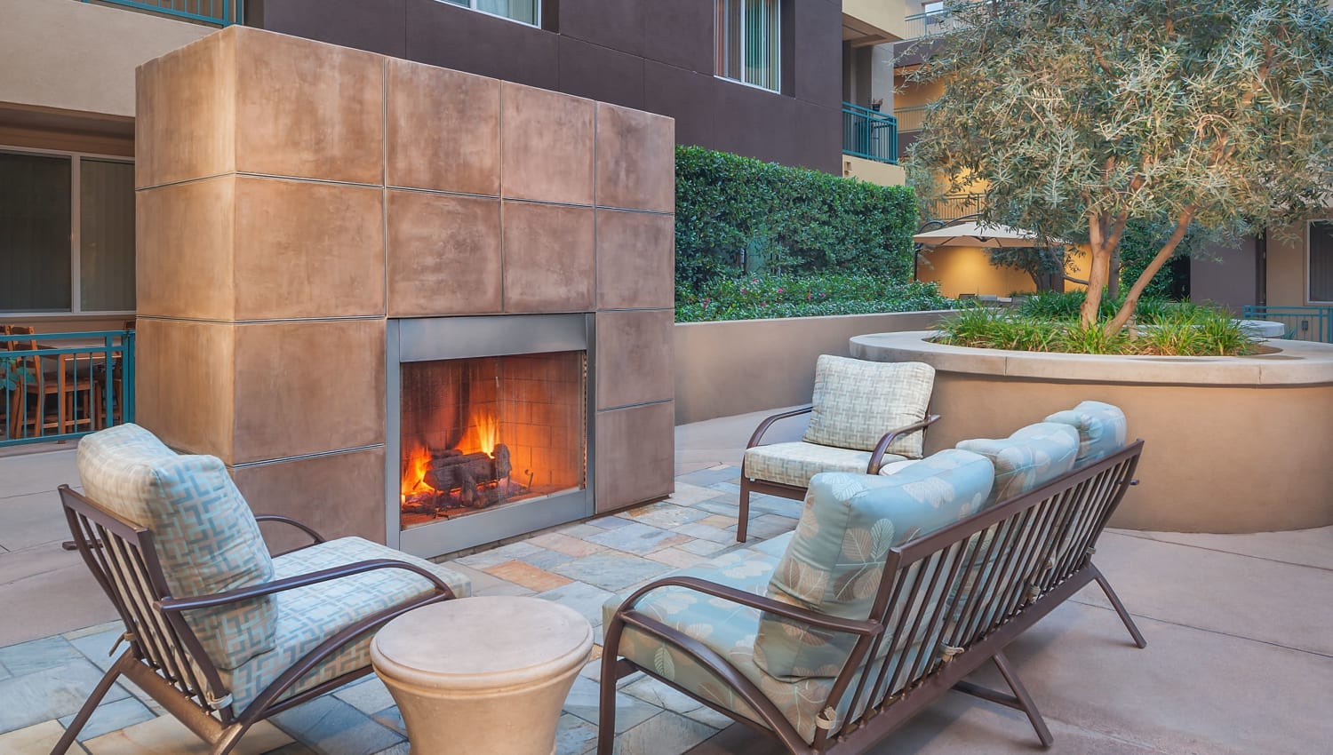 Outdoor fireplace seating at The Pointe Apartments in Brea, California