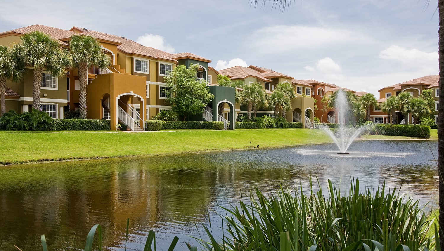 Exterior of Manatee Bay Apartments by the lake in Boynton Beach, Florida
