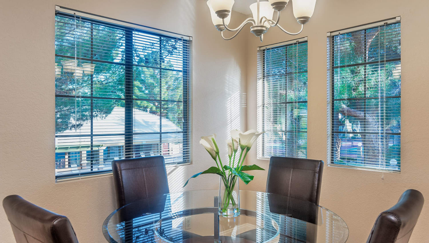 Well-furnished dining area with view of the community from a model home at Shelter Cove Apartments in Las Vegas, Nevada