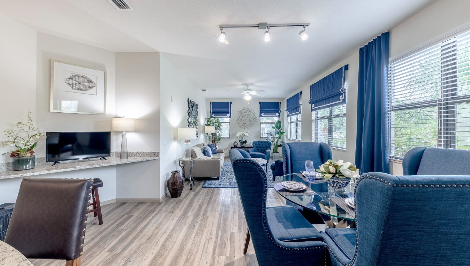 Model dining area and living room at The Hamptons at Palm Beach Gardens Apartments in Palm Beach Gardens, Florida
