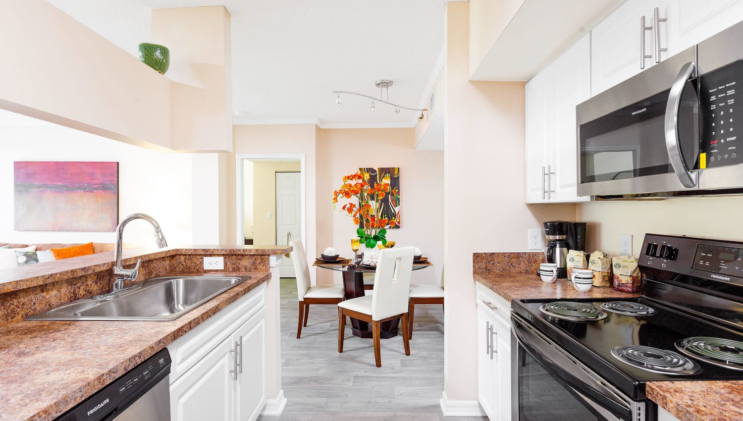 Model kitchen and dining room in apartment at Ibis Reserve Apartments in West Palm Beach, Florida