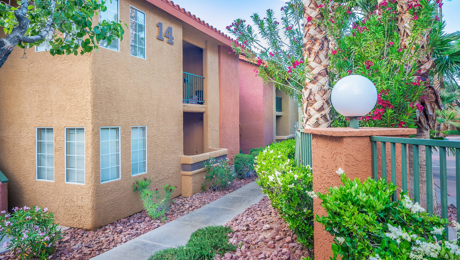Exterior of apartments and walkway view at Invitational Apartments in Henderson, Nevada