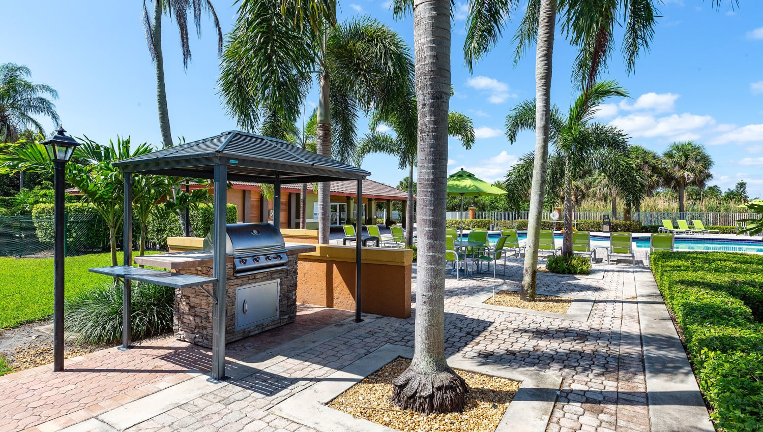 Pool and BBQ area at Whalers Cove Apartments in Boynton Beach, Florida