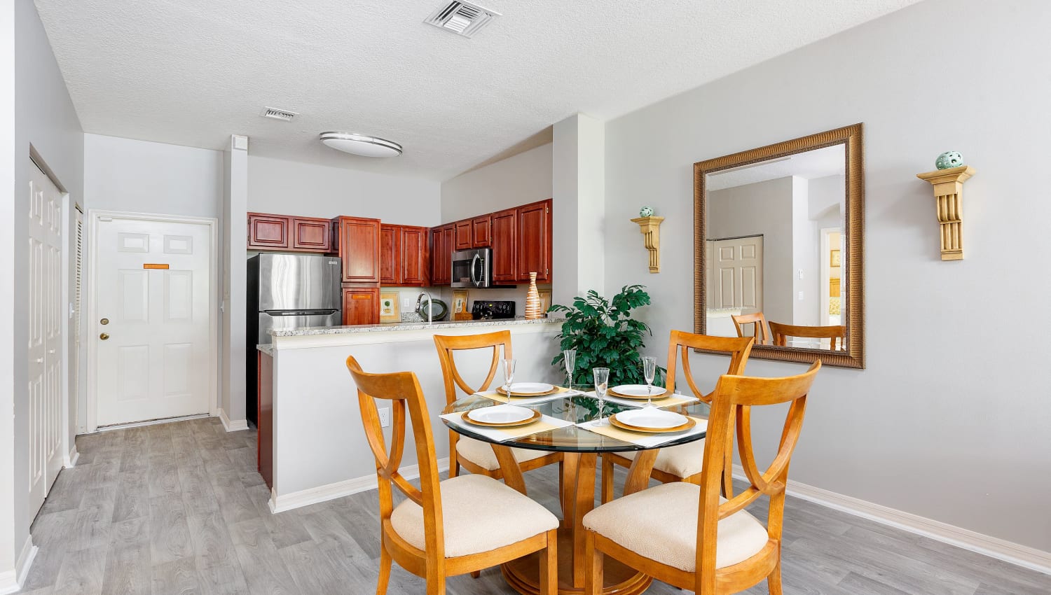 Model dining area and kitchen in apartment at Villas of Juno Apartments in Juno Beach, Florida