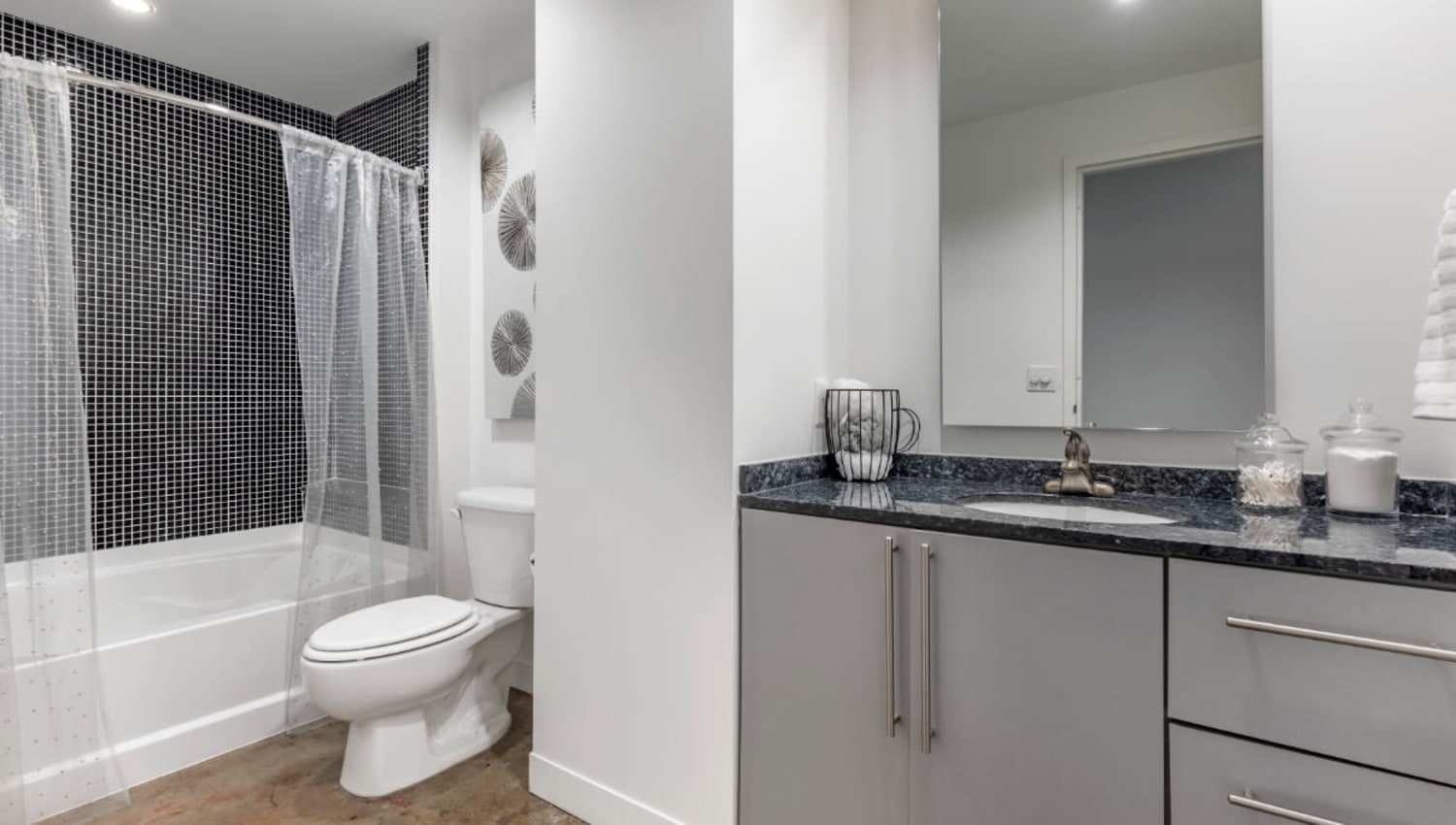 Bathroom with grey cabinetry at Mosaic Dallas in Dallas, Texas
