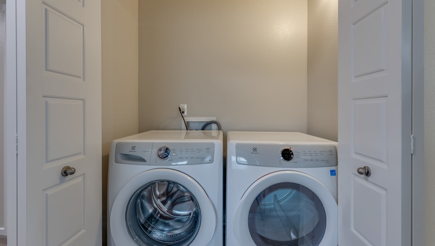 Full-sized washer and dryer in an apartment home at Olympus at Ten Mile in Meridian, Idaho