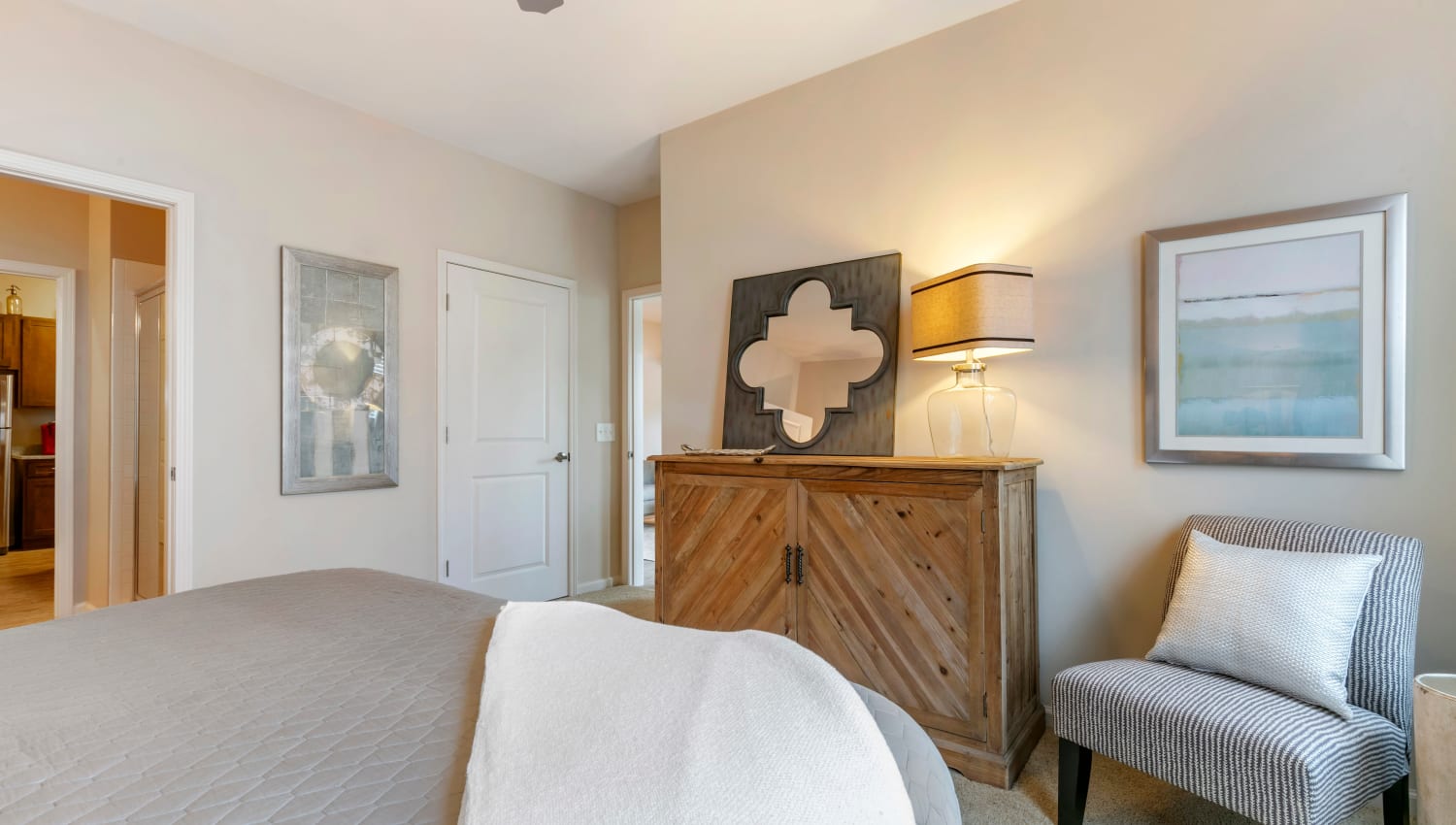 Model bedroom with a ceiling fan at The Village at Apison Pike in Ooltewah, Tennessee