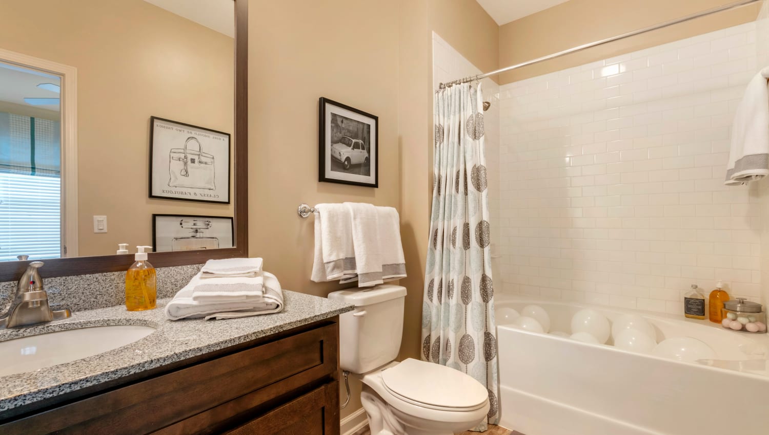 Bathroom with granite countertops and tiled shower at The Village at Apison Pike in Ooltewah, Tennessee
