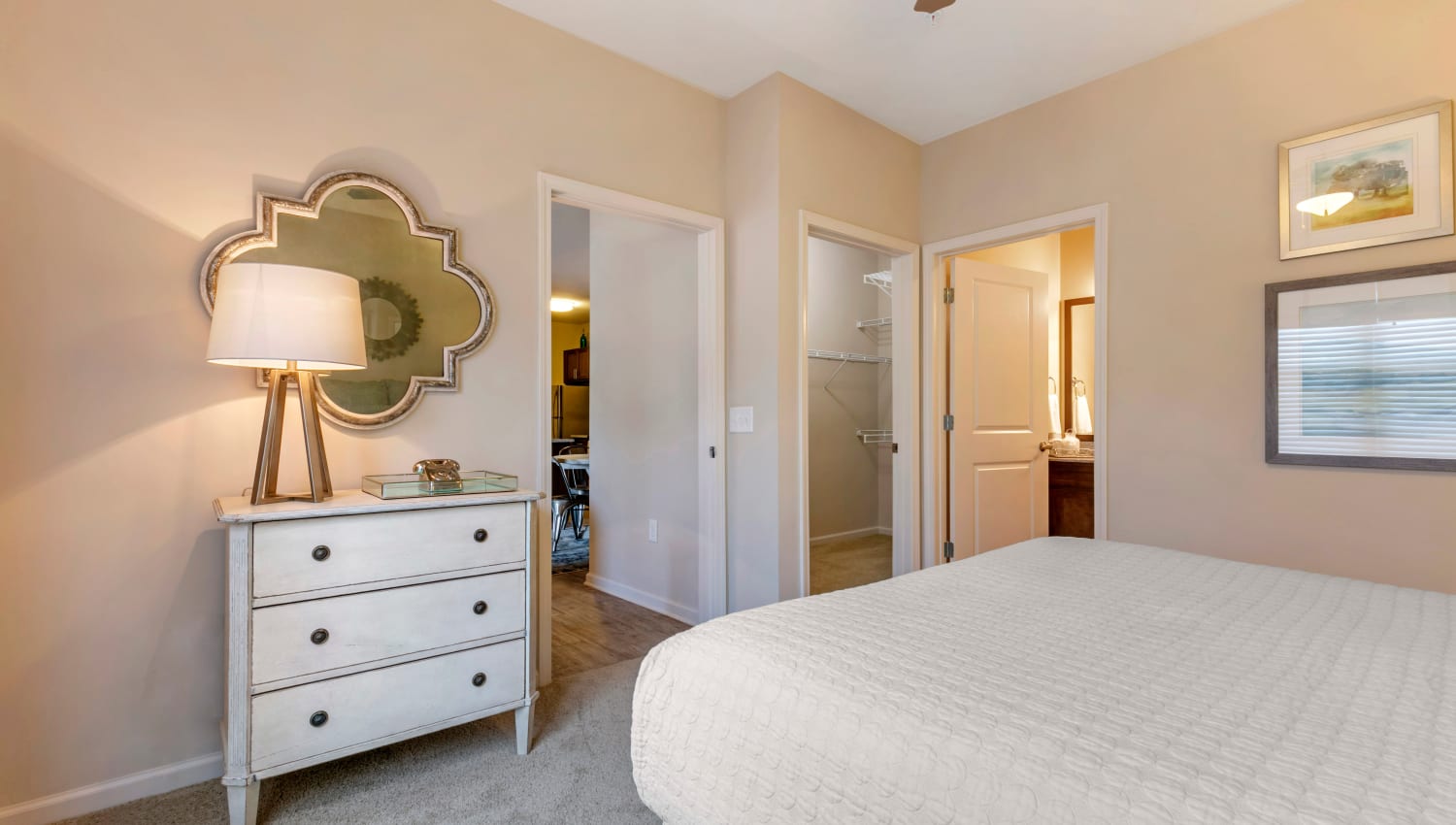Model bedroom with ensuite bathroom and walk-in closet at The Village at Apison Pike in Ooltewah, Tennessee