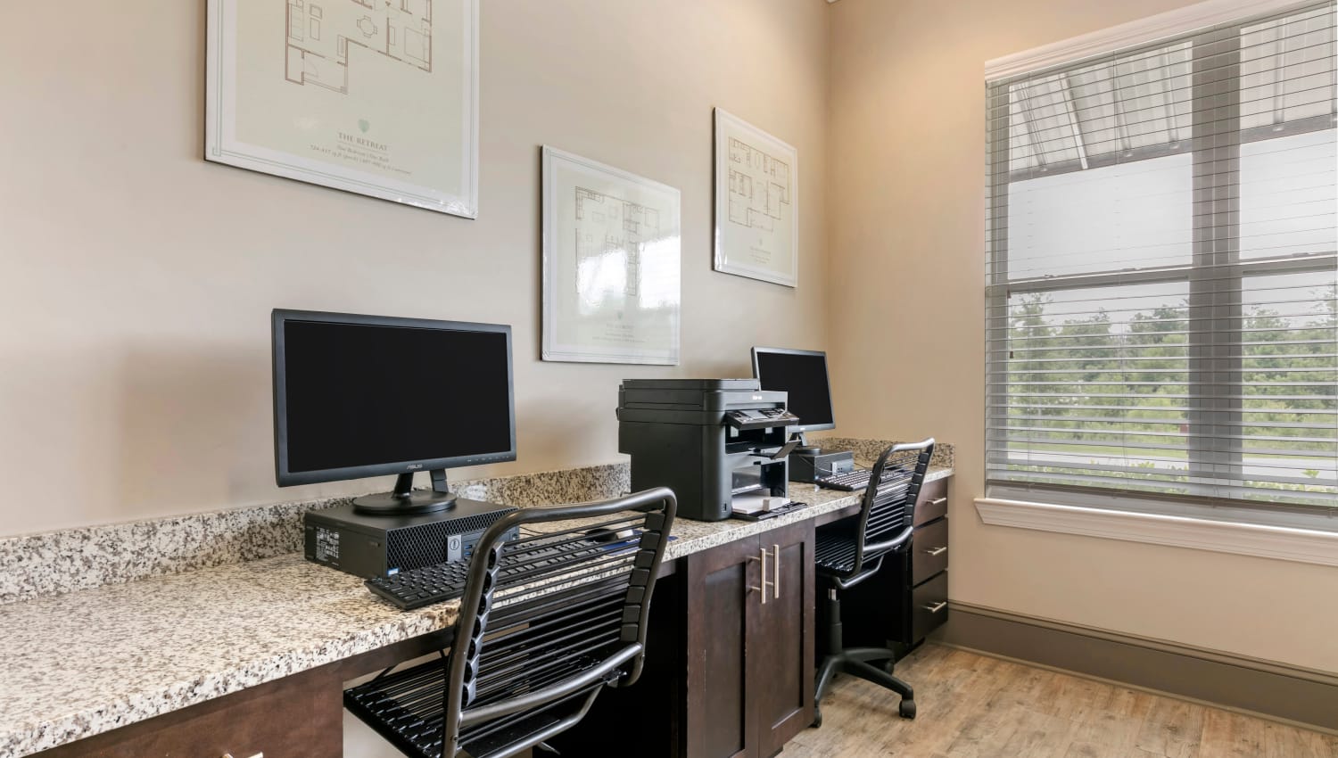 Business center with desktop PCs and a printer at The Village at Apison Pike in Ooltewah, Tennessee