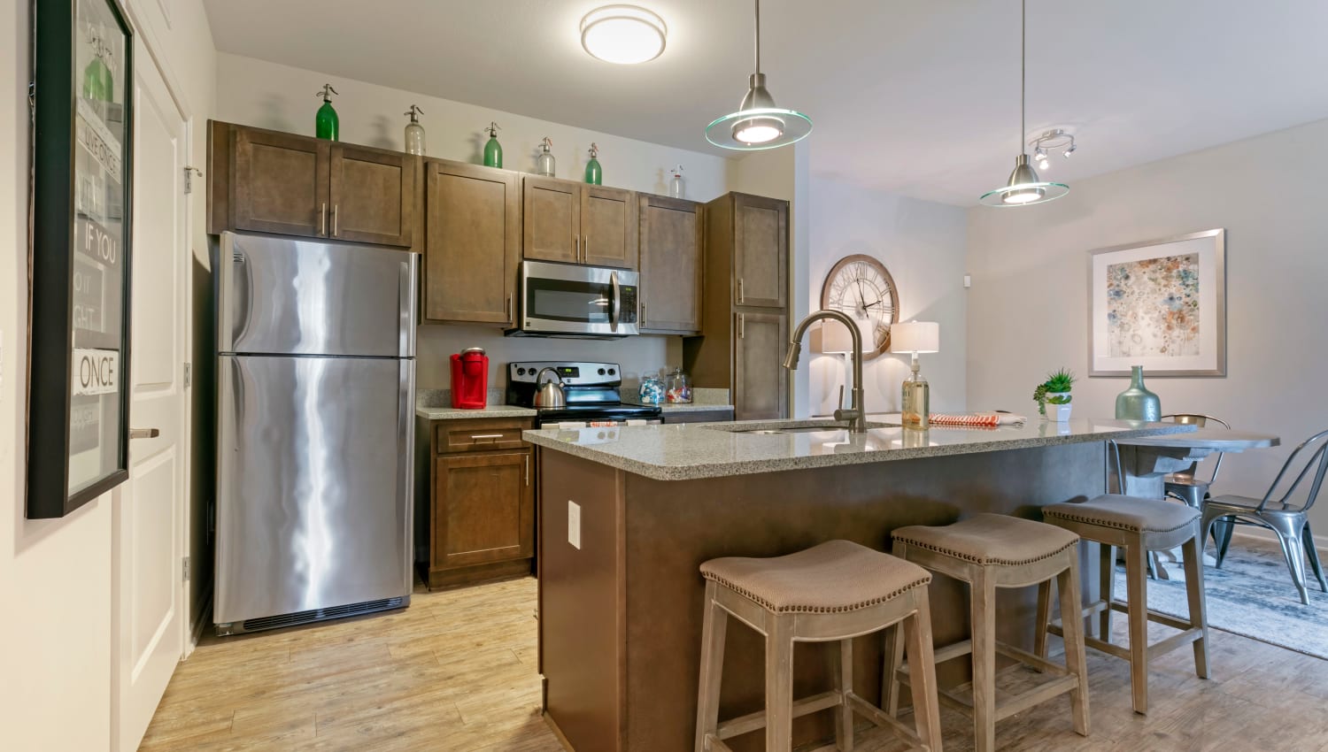 Modern kitchen with a breakfast bar and stainless steel appliances at The Village at Apison Pike in Ooltewah, Tennessee