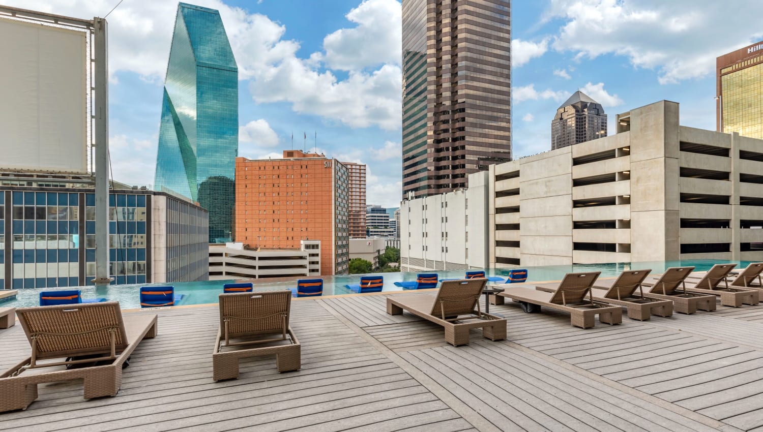 Out door seating around rooftop infinity pool at Mosaic Dallas in Dallas, Texas