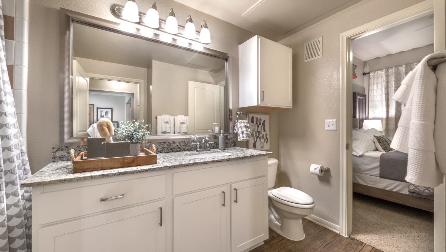 Bathroom with granite countertops and plenty of storage space at 75 West in Dallas, Texas